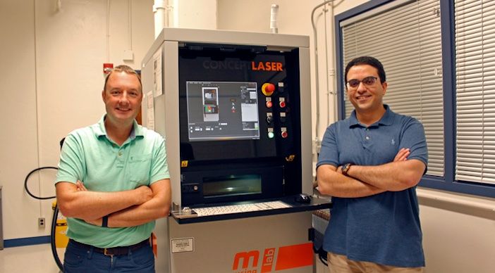 researchers in front of a machine