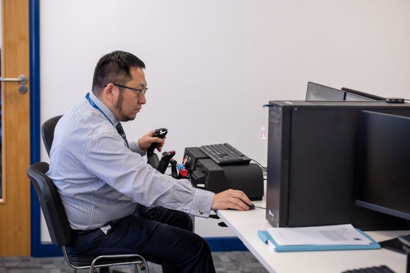 Cranfield engineer testing using a flight simulator 