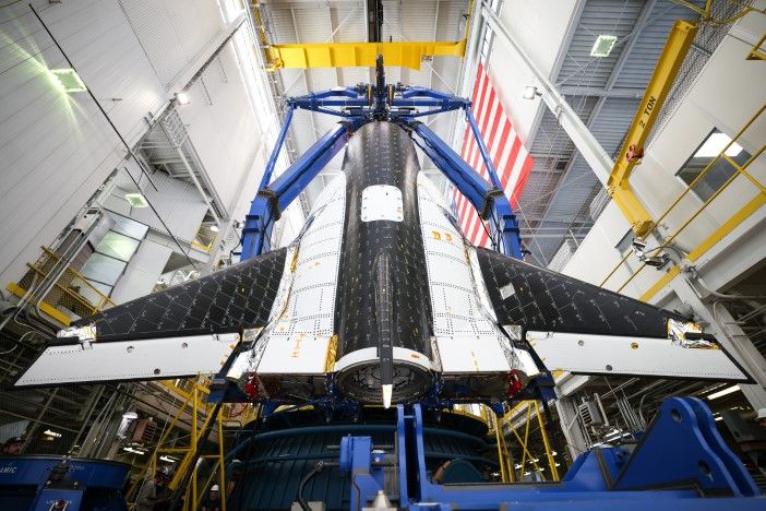 Overhead perspective of Dream Chaser spaceplane showing complete wing span and lifting-body design during structural test preparations in high bay facility