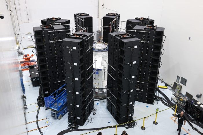 Extensive data acquisition system with multiple electronic equipment racks surrounding Dream Chaser structural test article, demonstrating the complexity of spacecraft verification testing