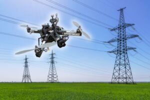Drone flying near electrical transmission towers in outdoor setting