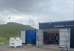 Exterior view of MachLab facility showing containers and test equipment at former RAF base