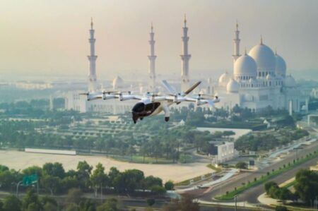 Archer's Midnight eVTOL aircraft flying over Abu Dhabi cityscape with mosque in background