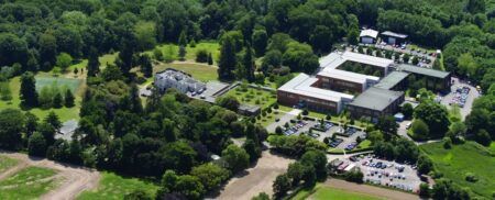 Aerial view of Roke's headquarters facility showing modern buildings surrounded by green landscape Roke's headquarters facility where the company develops defense and national security solutions including the ZODIAC battlefield intelligence