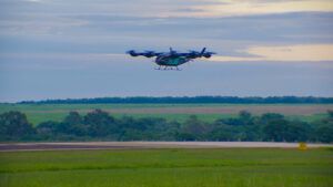 Eve Air Mobility eVTOL prototype hovering above runway during first untethered flight test in Brazil