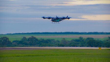 Eve Air Mobility eVTOL prototype hovering above runway during first untethered flight test in Brazil