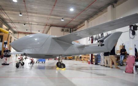 AIR reveals production cargo eVTOL AIR production model eVTOL cargo aircraft displayed in manufacturing facility showing fixed-wing configuration and tricycle landing gear