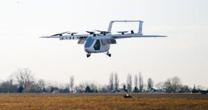 ERC System Romeo eVTOL prototype in hover flight over an airfield with eight rotors deployed