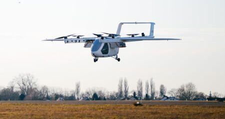 ERC System Romeo eVTOL prototype in hover flight over an airfield with eight rotors deployed