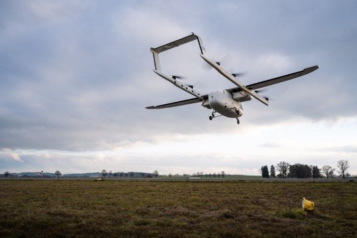 Romeo eVTOL prototype climbing in flight over open farmland showing its fixed-wing configuration