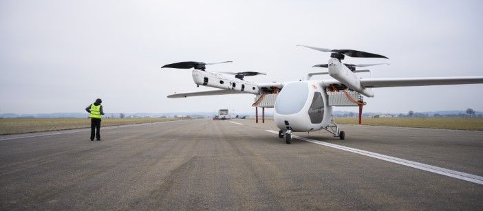 Romeo eVTOL prototype on runway with ground crew member in high-visibility vest