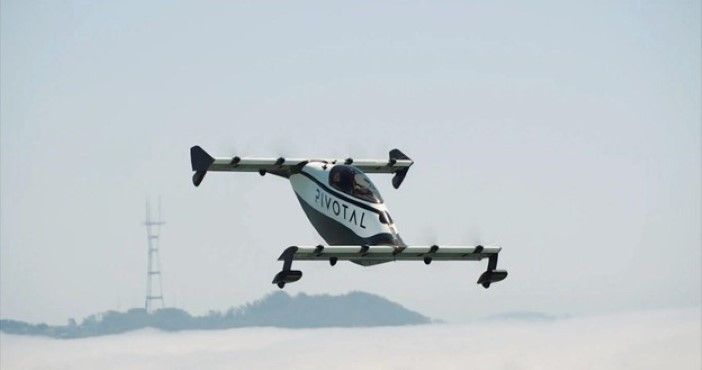 Pivotal eVTOL in forward flight over a misty landscape