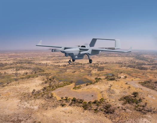 Rendering of the Capa-X uncrewed aerial system in flight over arid terrain
