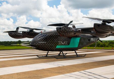 Eve flies full-scale eVTOL prototype for Brazilian government Eve Air Mobility's full-scale eVTOL engineering prototype on the runway at Embraer's Gavião Peixoto test facility, showing the lift-plus-cruise configuration with wing-mounted rotors and rear pusher propeller