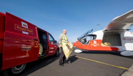 Royal Mail trials electric aircraft in Scotland Royal Mail worker loading mail sacks from a delivery van into a BETA Technologies ALIA electric aircraft on an airport apron