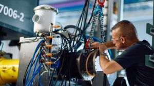 A technician works on a megawatt-class electric motor generator at Collins Aerospace's Grid testing facility in Rockford, Illinois