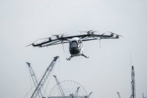 SkyDrive SD-05 eVTOL aircraft in flight over Tokyo Bay