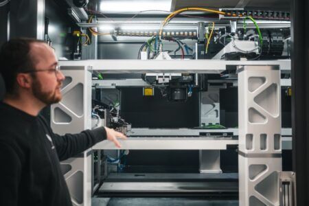 Vertical Aerospace launches battery production line for Valo eVTOL An engineer gestures toward automated battery manufacturing equipment at the Vertical Aerospace Energy Centre