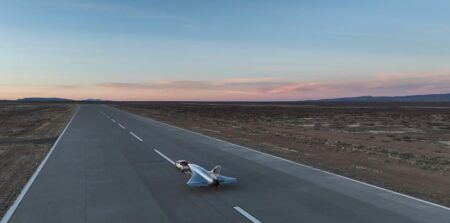 Hermeus begins supersonic flight test campaign with Quarterhorse aircraft Unmanned Quarterhorse Mk 2.1 aircraft on the runway at Spaceport America with desert landscape at dusk