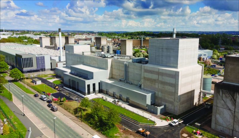 Aerial view of Rolls-Royce's Testbed 80 facility at the Derby site, showing the large concrete testbed buildings under a partly cloudy sky