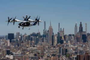 Joby Aviation eVTOL aircraft in flight above Lower Manhattan with One World Trade Center in the background