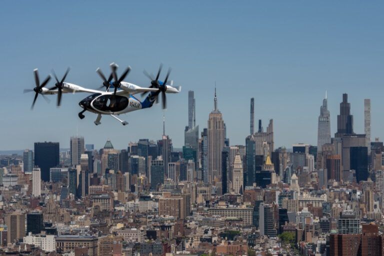 Joby Aviation eVTOL aircraft in flight above Lower Manhattan with One World Trade Center in the background