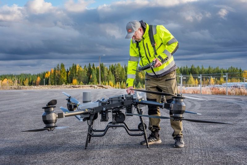 VTT senior scientist Jussi Kangasoja inspecting a large multirotor drone on the apron at the organization's test site in northern Finland