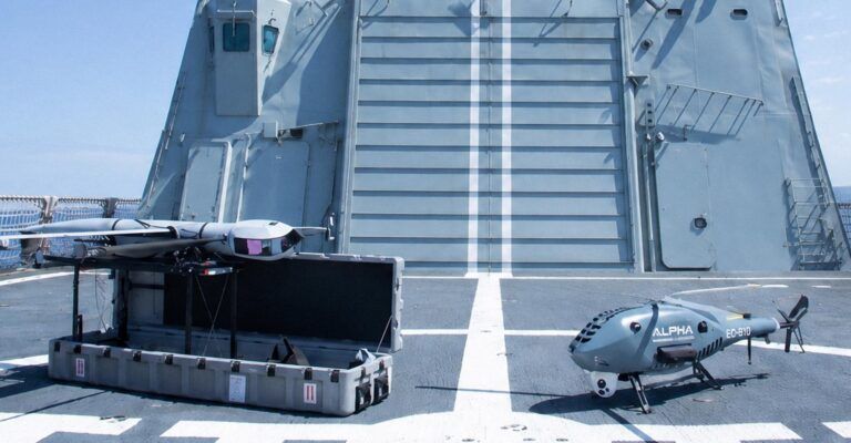 Airbus validates drone wingman control from H135 helicopter in naval trial Alt text: Airbus Flexrotor UAS on launcher and Alpha Unmanned Systems A900 rotary-wing drone on the flight deck of Spanish Navy offshore patrol vessel Rayo