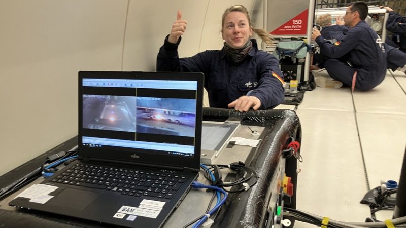 A researcher from the Federal Institute for Materials Research and Testing monitors the laser regolith-melting experiment on board the A310 Zero-G