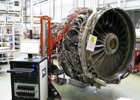 MK Test Systems Automeg automatic test equipment connected to a large turbofan engine undergoing electrical checks in a maintenance facility