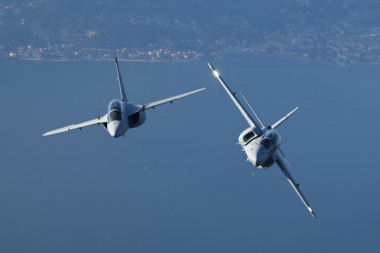 ITPS Canada orders Leonardo M-346 jet trainer Two Leonardo M-346 advanced jet trainers in loose formation flight over a coastal landscape