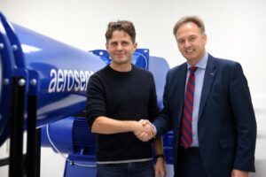 Barney Garrood of Aero Sensor and Paul Crowhurst of Evolution Measurement Group shaking hands in front of an aerosensor-branded flow probe rig