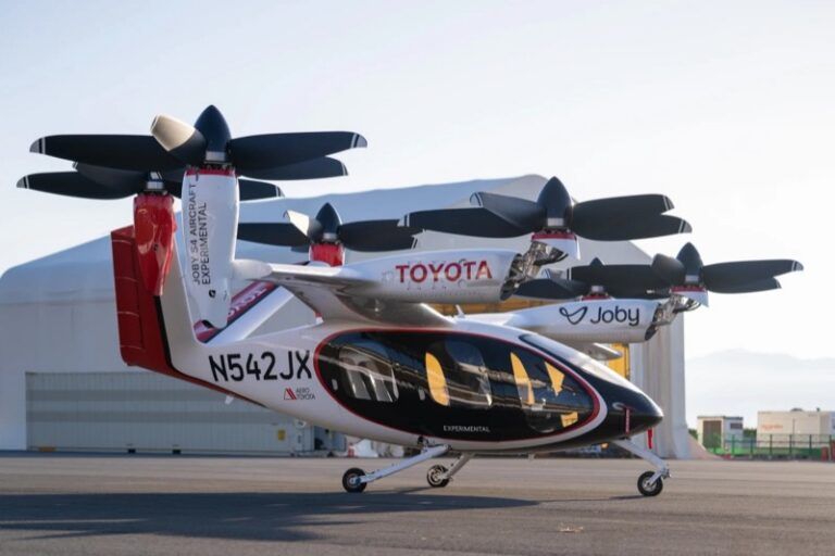 Joby and Toyota to scale up eVTOL manufacturing Alt text: Joby S4 aircraft displaying Toyota and Joby branding parked on an airfield apron with its rotors raised