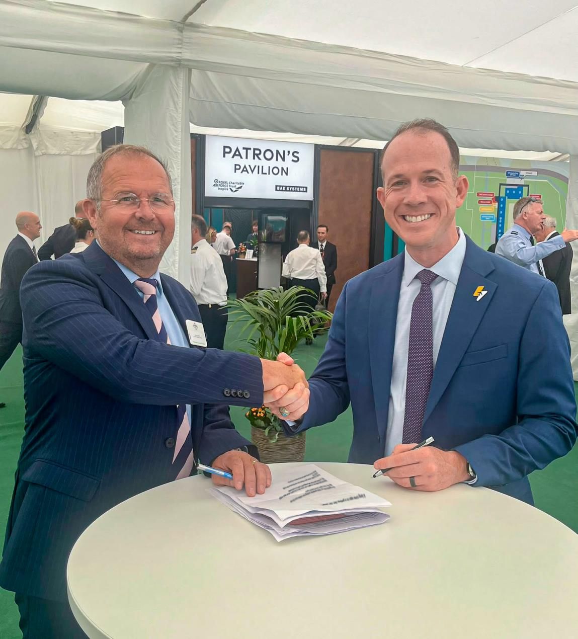 Andy Offer of 2Excel Aviation, left, and Jake Ashmore of Electra shake hands over the signed agreement at an industry event