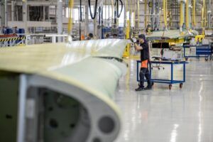 Airbus workers assemble aircraft wings on the production line inside the Broughton wing factory