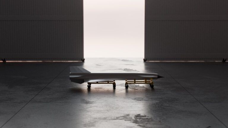 Hermeus reveals air-launched expendable hypersonic testbed Ramjet-X Rendering of the slender, dart-shaped Ramjet-X hypersonic test vehicle on a wheeled cradle in a darkened hangar, with light coming through the open doorway