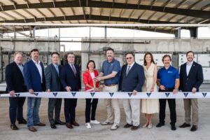 Venus Aerospace and Texas Space Commission representatives cut a ribbon in front of the new propulsion test stand at the Houston Spaceport