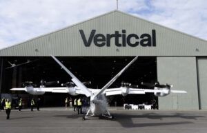 Vertical Aerospace's Valo electric air taxi outside the company's hangar at Cotswold Airport, with staff standing around it