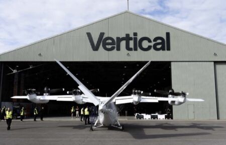 Vertical Aerospace's Valo electric air taxi outside the company's hangar at Cotswold Airport, with staff standing around it